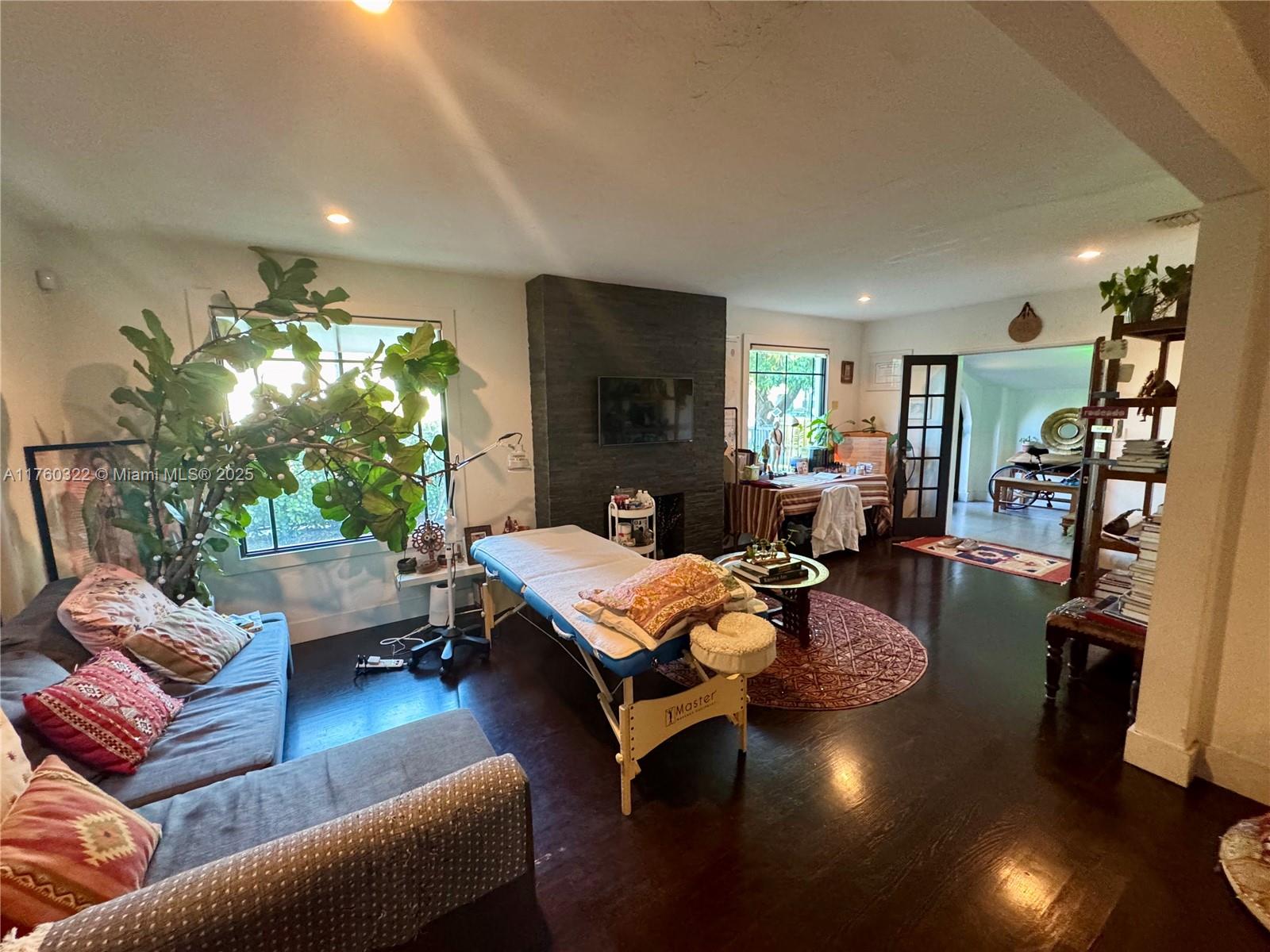 7020 Northeast 5th Avenue Miami, FL 33138 - Photo 3 of 42 a living room with furniture and a flat screen tv