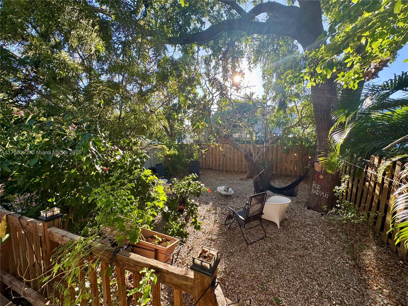 7020 Northeast 5th Avenue Miami, FL 33138 - Photo 34 of 42 a backyard of a house with table and chairs