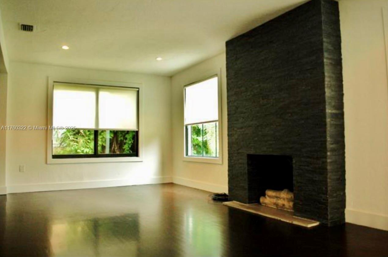 7020 Northeast 5th Avenue Miami, FL 33138 - Photo 35 of 42 a living room with a fireplace and a window