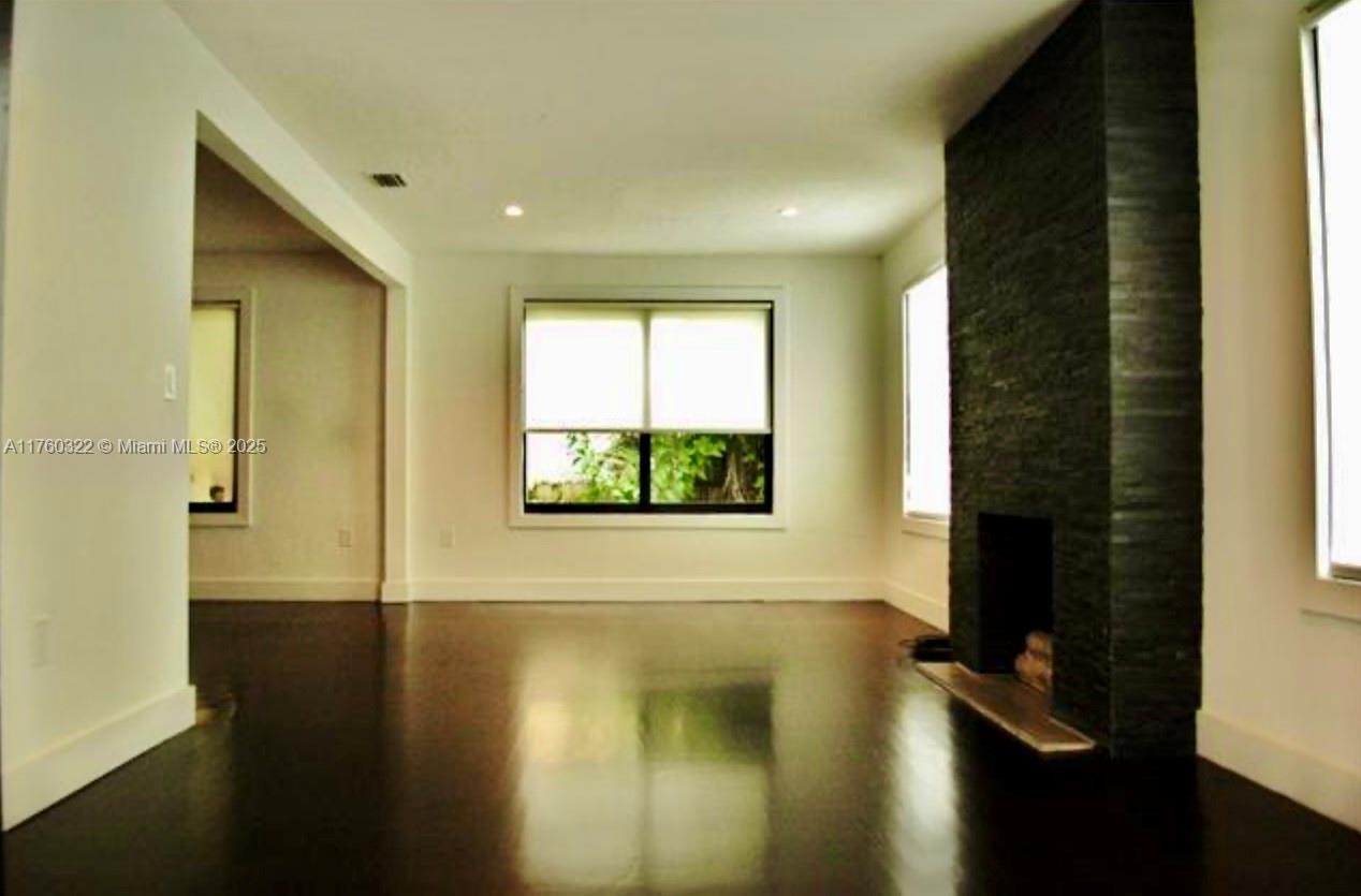 7020 Northeast 5th Avenue Miami, FL 33138 - Photo 36 of 42 a view of a hallway with wooden floor