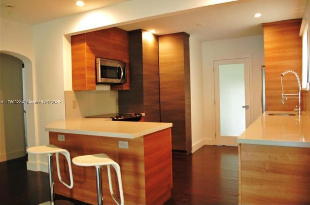 7020 Northeast 5th Avenue Miami, FL 33138 - Photo 39 of 42 a bathroom with a tub sink and mirror