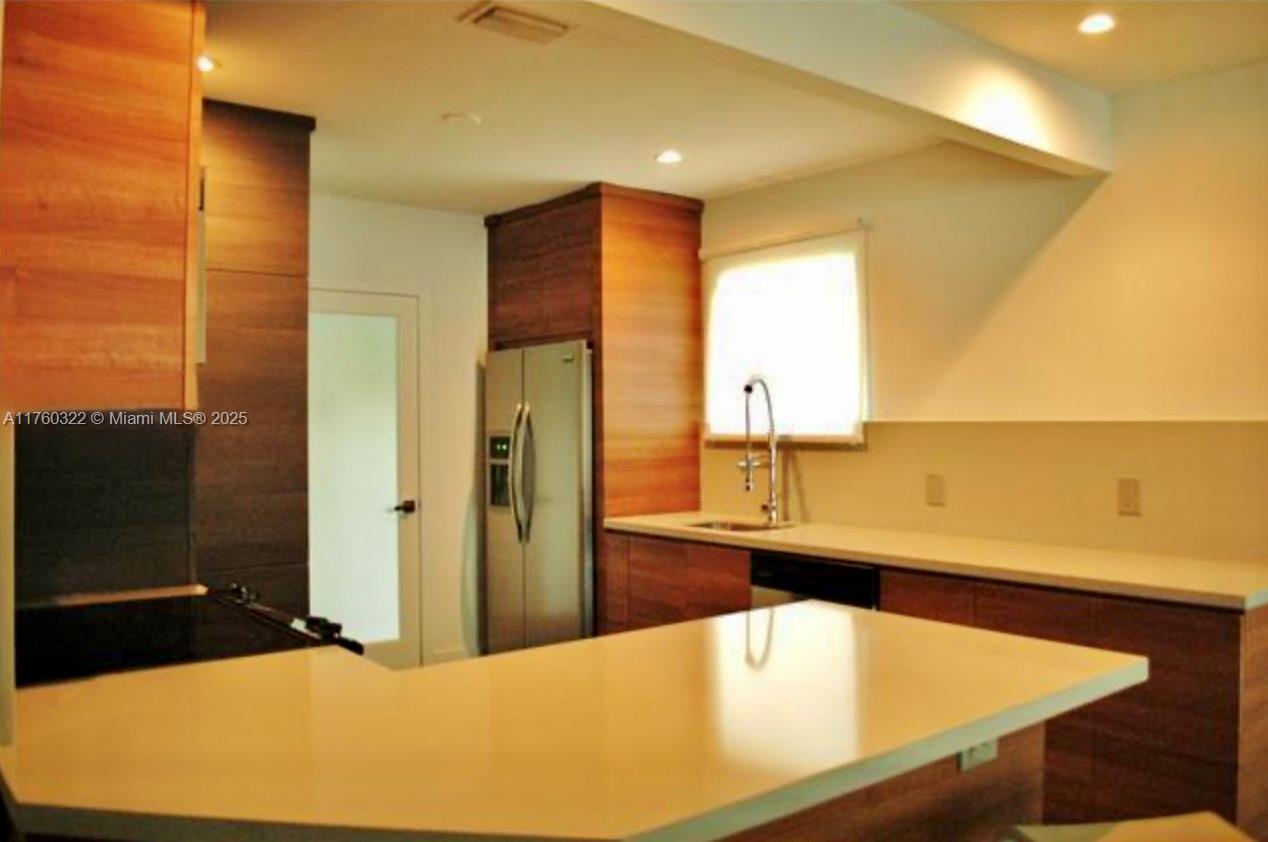 7020 Northeast 5th Avenue Miami, FL 33138 - Photo 40 of 42 a bathroom with a tub and sink