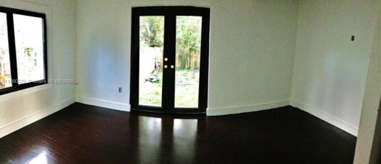 7020 Northeast 5th Avenue Miami, FL 33138 - Photo 42 of 42 an empty room with wooden floor and windows