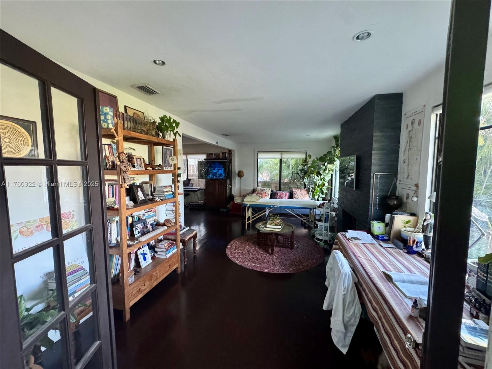 7020 Northeast 5th Avenue Miami, FL 33138 - Photo 7 of 42 a living room with furniture and a floor to ceiling window