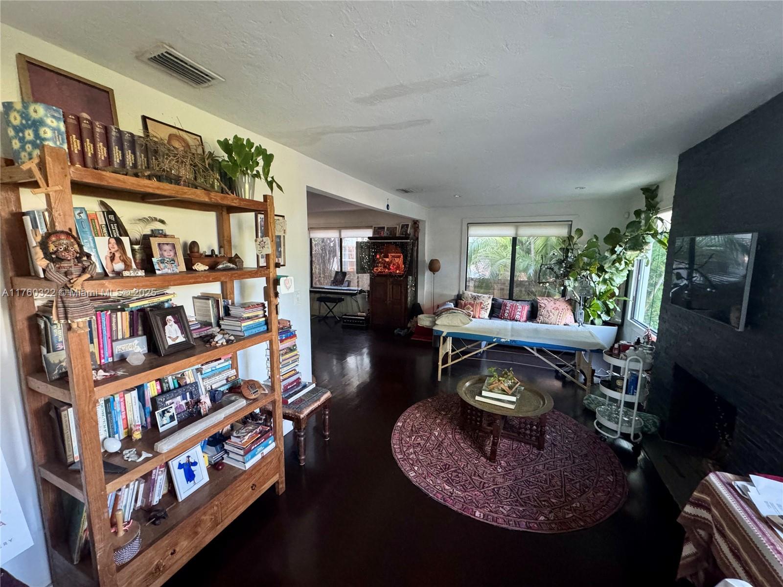 7020 Northeast 5th Avenue Miami, FL 33138 - Photo 8 of 42 a living room with furniture and a book shelf