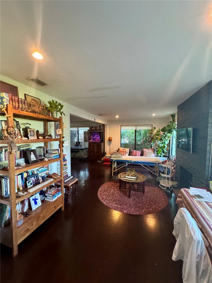 7020 Northeast 5th Avenue Miami, FL 33138 - Photo 9 of 42 a living room with furniture and a book shelf