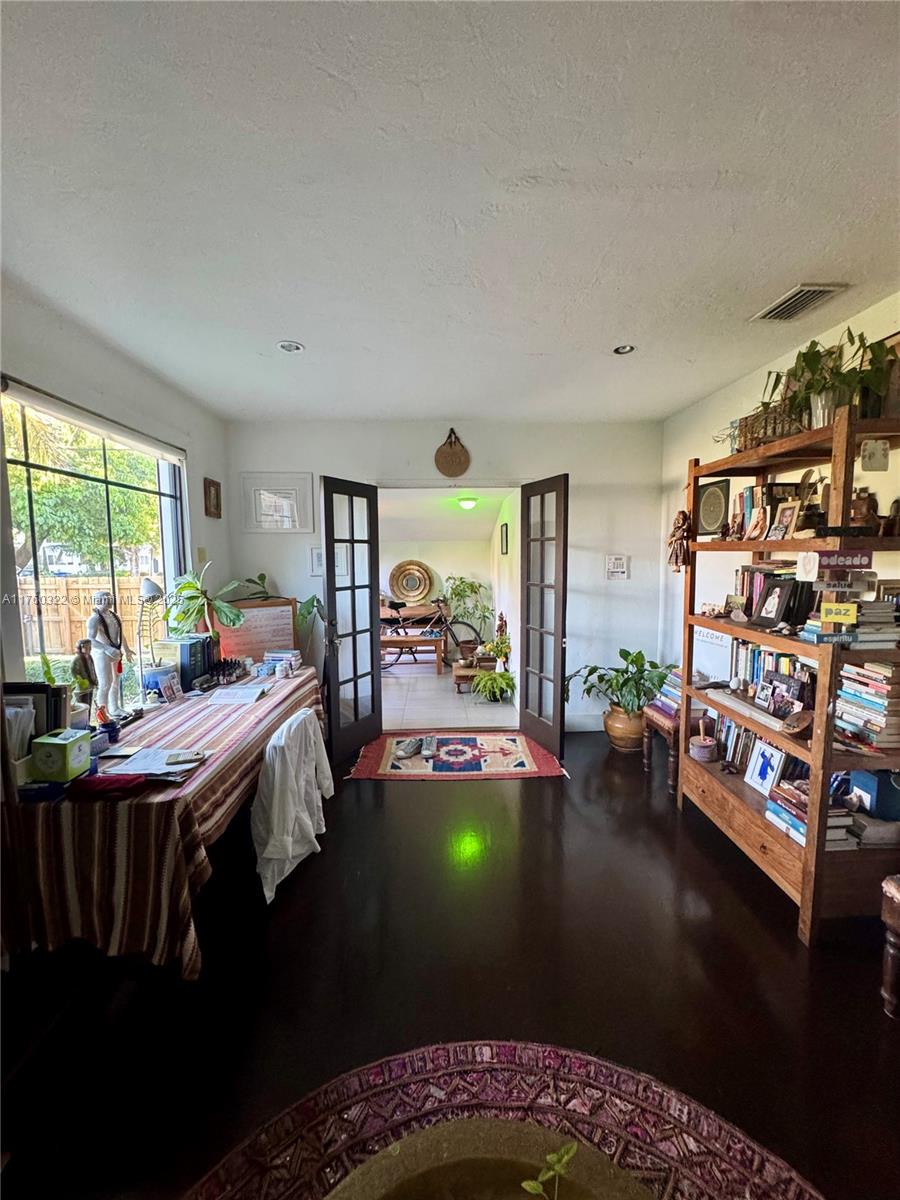 7020 Northeast 5th Avenue Miami, FL 33138 - Photo 10 of 42 a bed room with furniture and a window