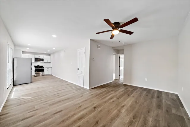 a view of an empty room with a ceiling fan