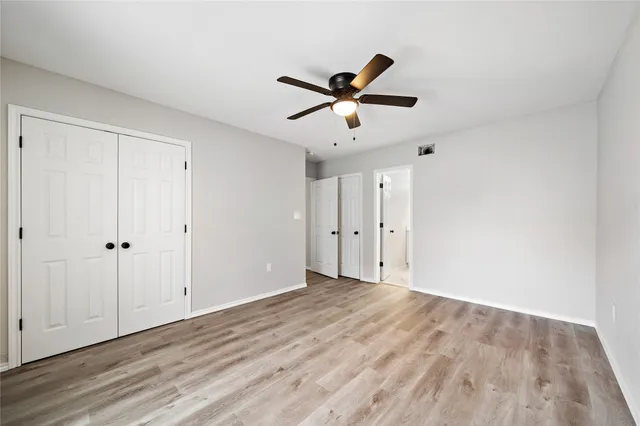 a view of empty room with wooden floor