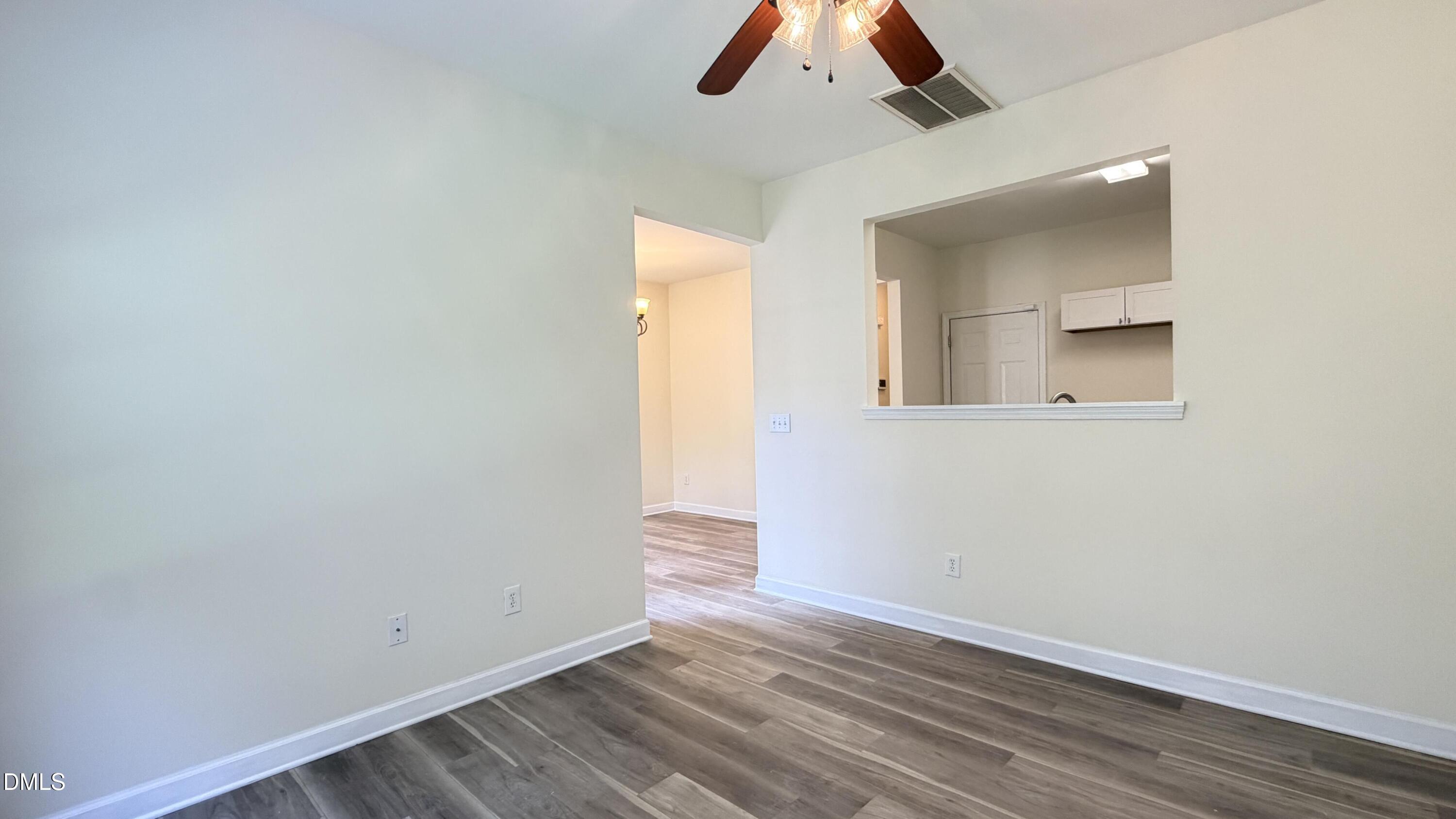 4123 Standing Rock Way Raleigh, NC 27604 - Photo 10 of 29 an empty room with wooden floor and windows