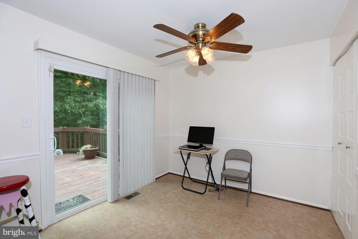 1725 Logmill Lane Gaithersburg, MD 20879 - Photo 12 of 30 a view of a livingroom with a ceiling fan & a window