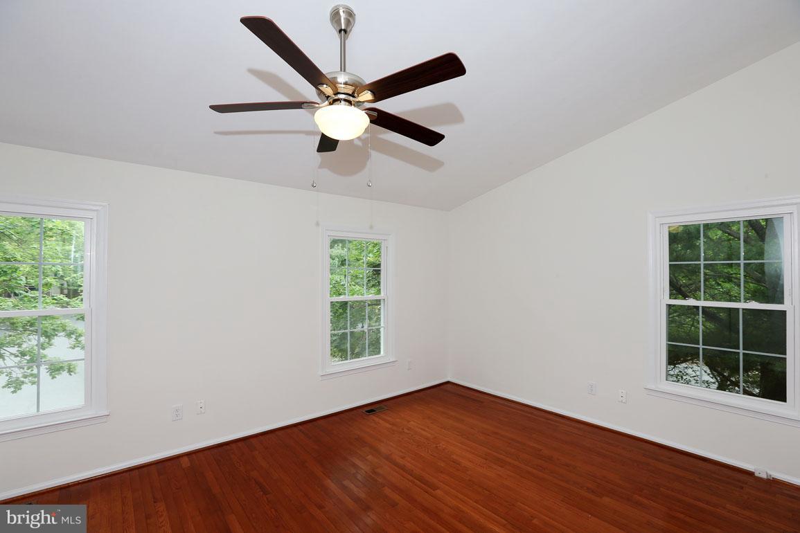 1725 Logmill Lane Gaithersburg, MD 20879 - Photo 18 of 30 an empty room with wooden floor windows and fan