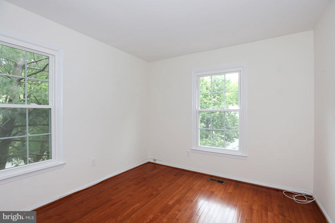 1725 Logmill Lane Gaithersburg, MD 20879 - Photo 21 of 30 an empty room with wooden floor and windows