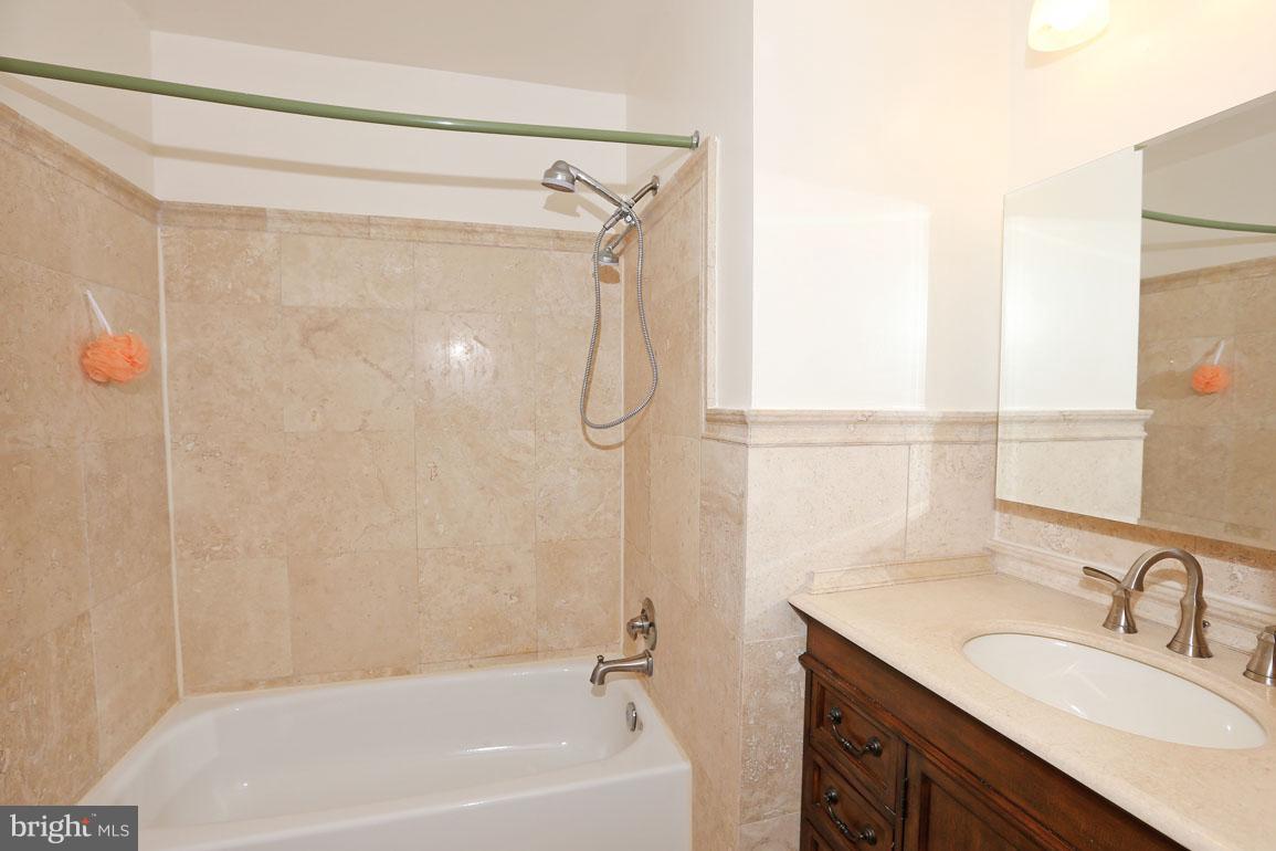 1725 Logmill Lane Gaithersburg, MD 20879 - Photo 23 of 30 a bathroom with a granite countertop sink toilet and shower