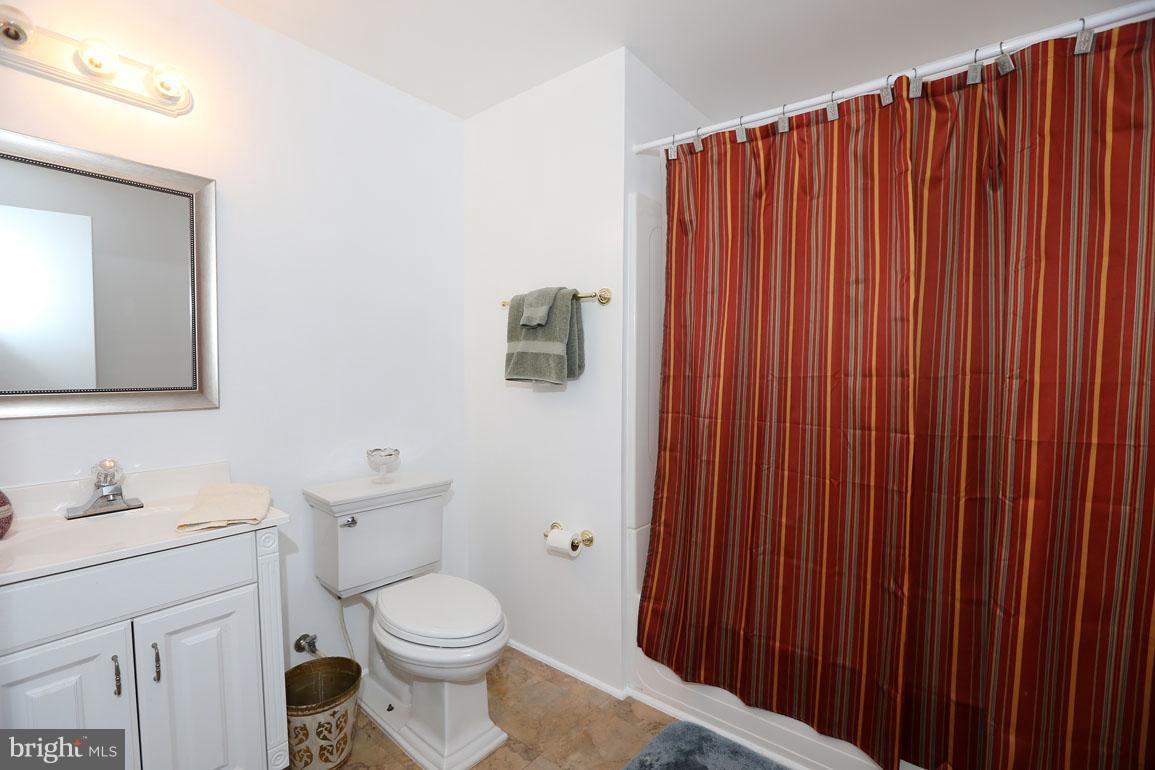 1725 Logmill Lane Gaithersburg, MD 20879 - Photo 26 of 30 a bathroom with a toilet a sink and mirror