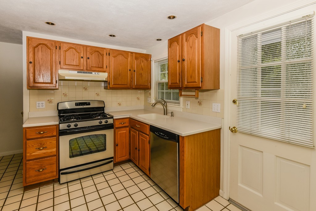 36 Clough Road, Unit 36 Dedham, MA 02026 - Photo 6 of 19 a kitchen with stainless steel appliances granite countertop a sink stove and cabinets