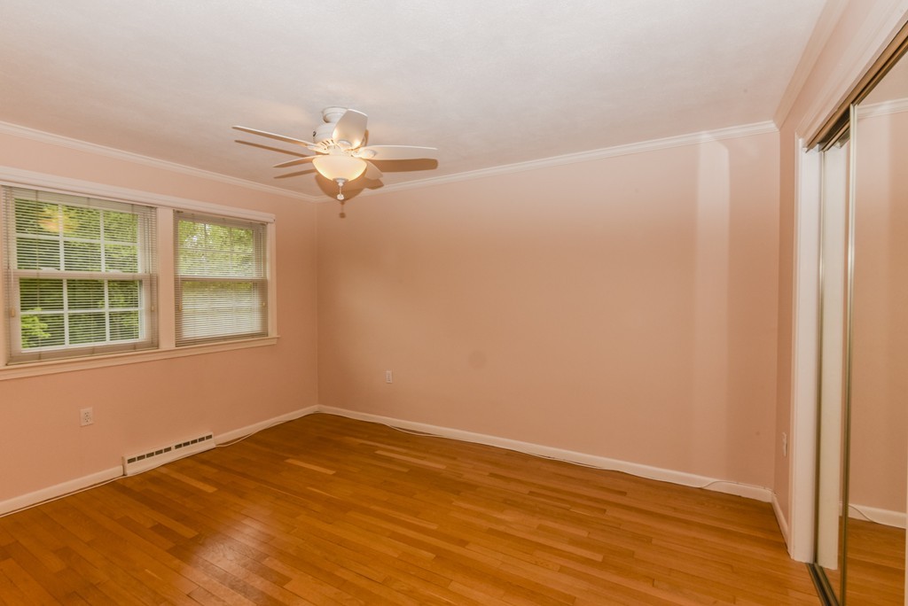 36 Clough Road, Unit 36 Dedham, MA 02026 - Photo 9 of 19 an empty room with wooden floor and windows