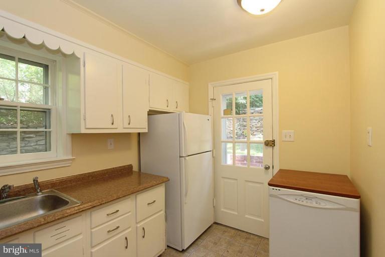104 Parkside Road Silver Spring, MD 20910 - Photo 4 of 13 a kitchen with a refrigerator sink and cabinets