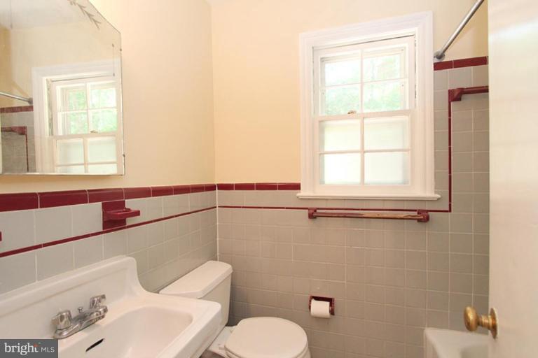 104 Parkside Road Silver Spring, MD 20910 - Photo 5 of 13 a bathroom with a toilet sink and mirror
