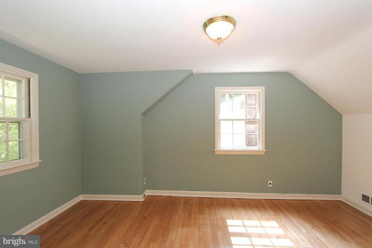 104 Parkside Road Silver Spring, MD 20910 - Photo 7 of 13 an empty room with wooden floor and windows