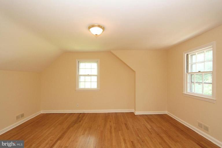 104 Parkside Road Silver Spring, MD 20910 - Photo 8 of 13 an empty room with wooden floor and windows