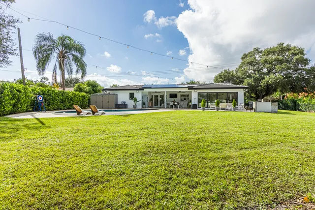 a front view of house with yard and outdoor seating
