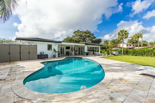 a view of a swimming pool with a yard