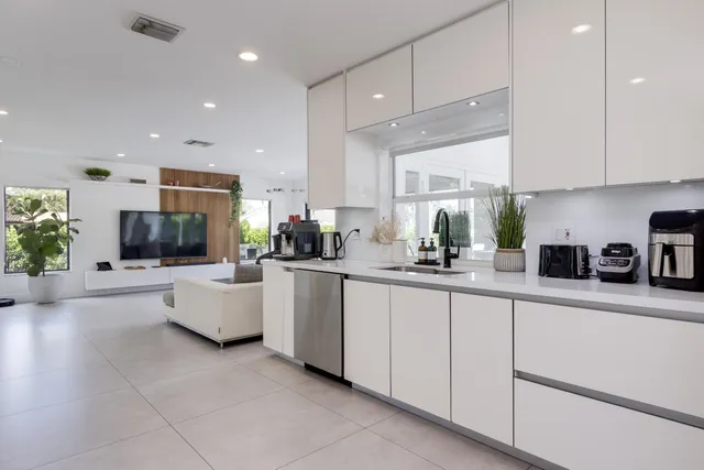 a kitchen with a refrigerator and a sink