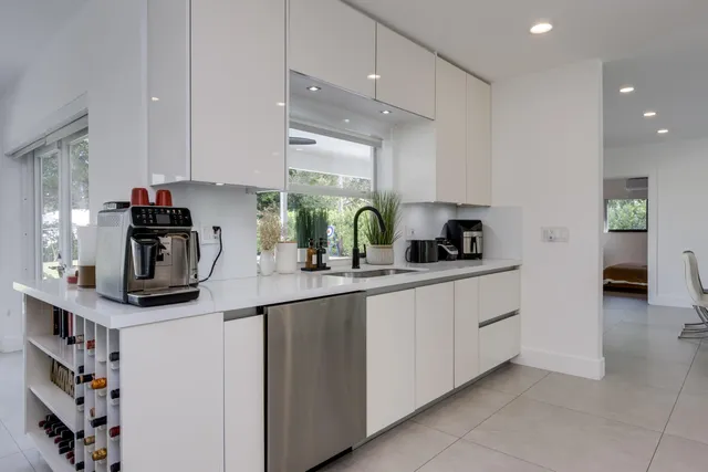 a living room with furniture and large windows