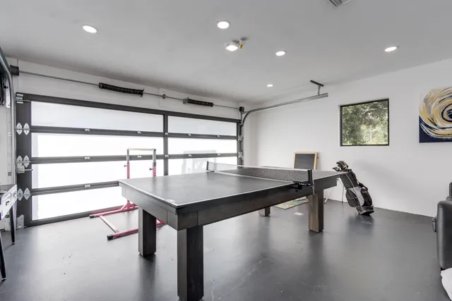 a bedroom with a large bed and a book shelf