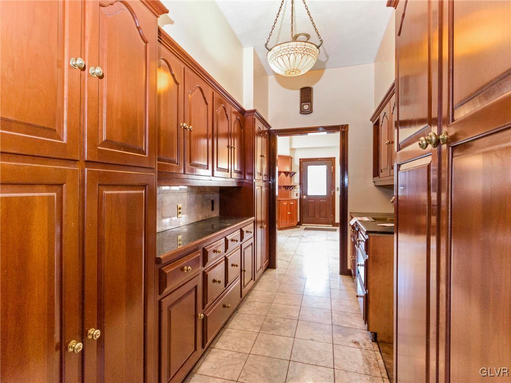 199 Evergreen Hollow Road Effort, PA 18330 - Photo 16 of 50 a kitchen with stainless steel appliances granite countertop a refrigerator a stove and a sink with wooden floor