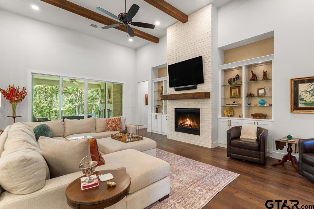 2926 Stewart Way Tyler, TX 75709 - Photo 2 of 33 a living room with furniture a fireplace and a flat screen tv