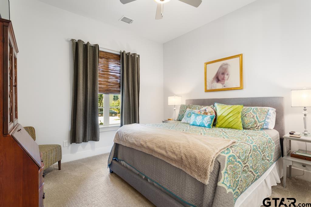 2926 Stewart Way Tyler, TX 75709 - Photo 21 of 33 a bedroom with a bed and a large window