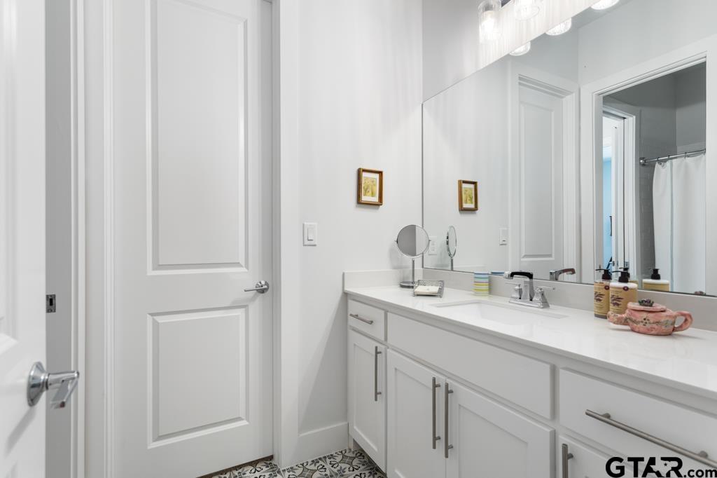 2926 Stewart Way Tyler, TX 75709 - Photo 22 of 33 a bathroom with a double vanity sink and a mirror
