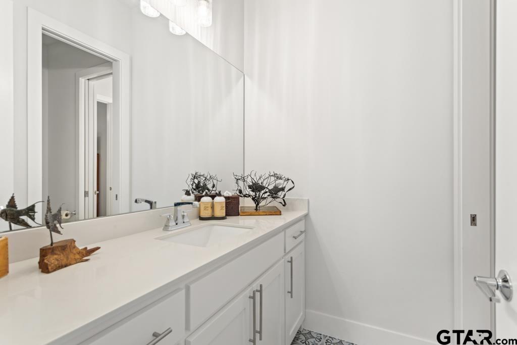 2926 Stewart Way Tyler, TX 75709 - Photo 24 of 33 a bathroom with a sink and a mirror