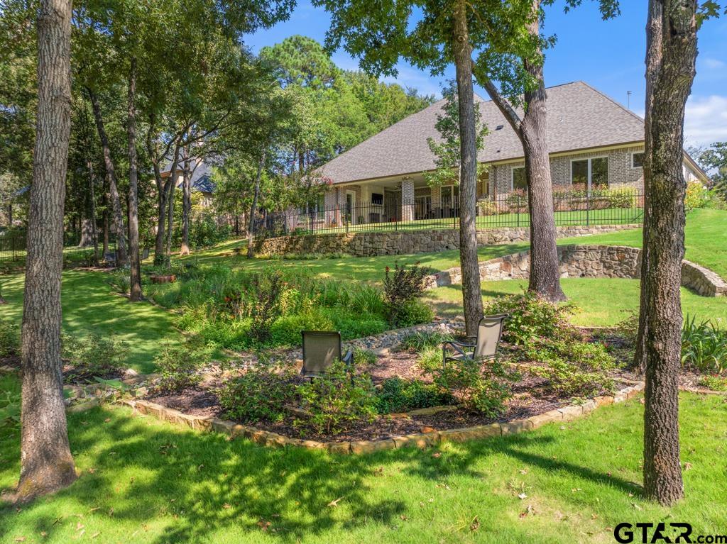 2926 Stewart Way Tyler, TX 75709 - Photo 29 of 33 a yellow and red house with a garden