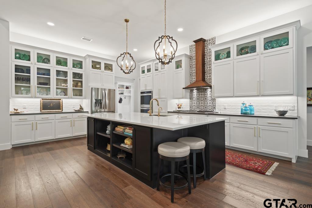2926 Stewart Way Tyler, TX 75709 - Photo 3 of 33 a kitchen with stainless steel appliances a large center island attached withe living room