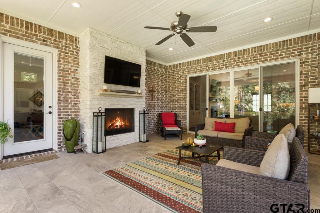 2926 Stewart Way Tyler, TX 75709 - Photo 4 of 33 a living room with furniture a flat screen tv and a fireplace