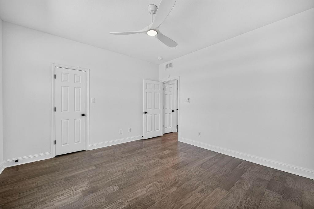 544 Gant Road Sherman, TX 75090 - Photo 28 of 39 White walls, wood-finish flooring, contemporary ceiling fan with integrated lighting, and multiple paneled doors