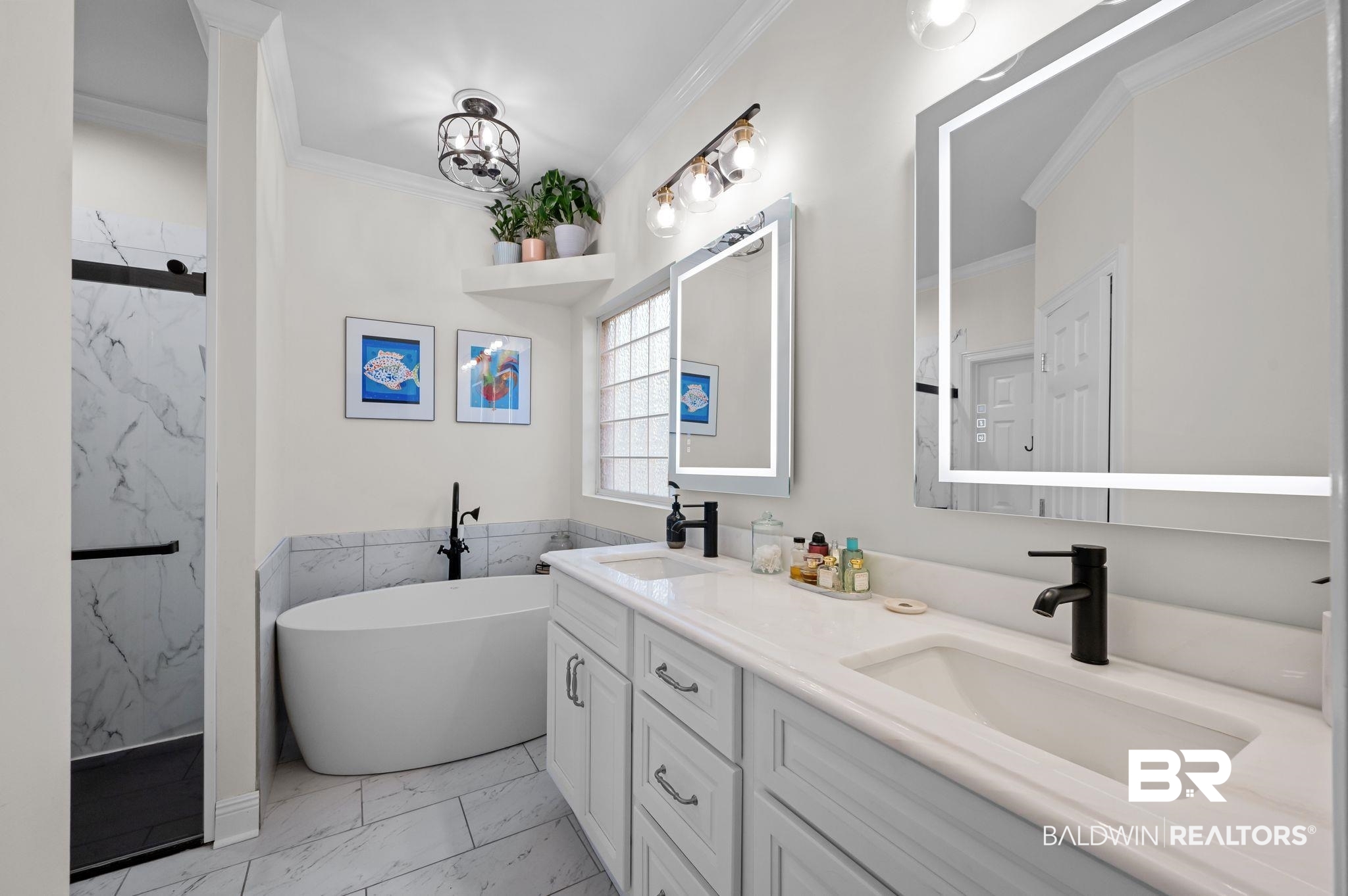 1825 Spring Hill Avenue Mobile, AL 36607 - Photo 19 of 43 Bathroom featuring double vanity, light marble finish flooring, a soaking tub, a marble finish shower, and crown molding