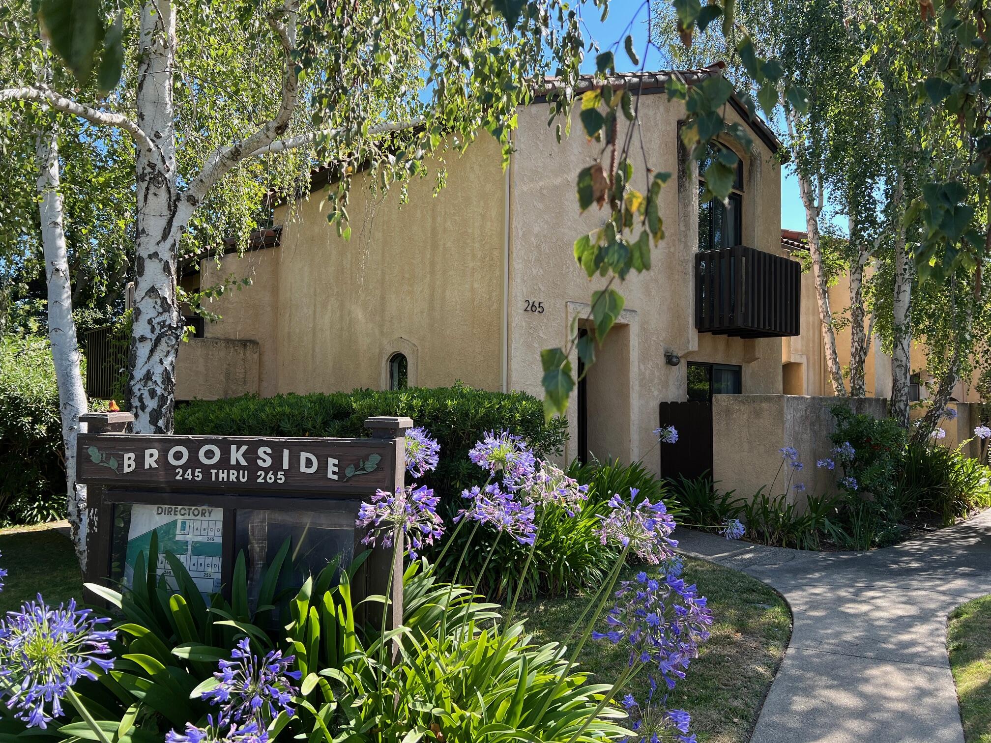 a sign that is in front of flowers