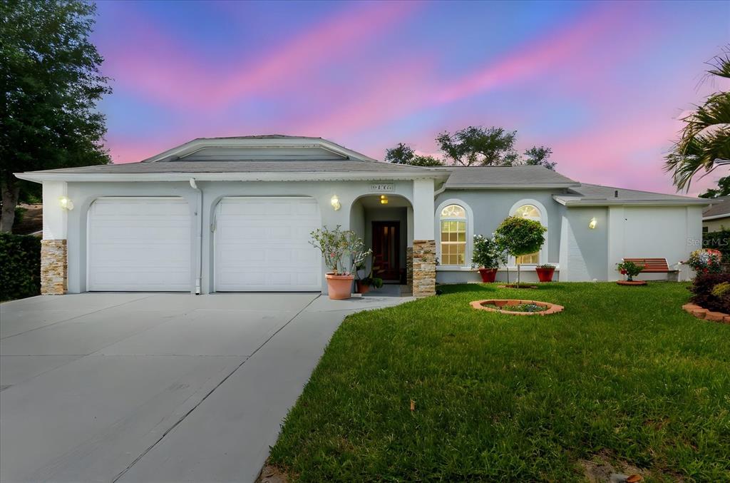 8112 Golden Bear Loop Port Richey, FL 34668 - Photo 1 of 88 a front view of a house with a yard and a garage