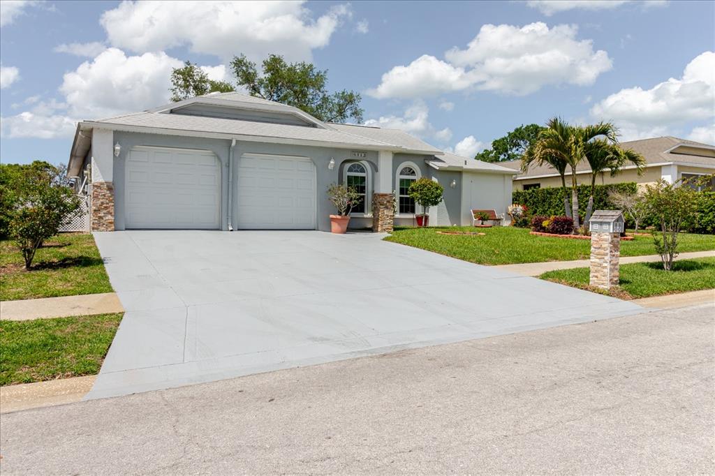 8112 Golden Bear Loop Port Richey, FL 34668 - Photo 11 of 88 front view of house with a yard and potted plants