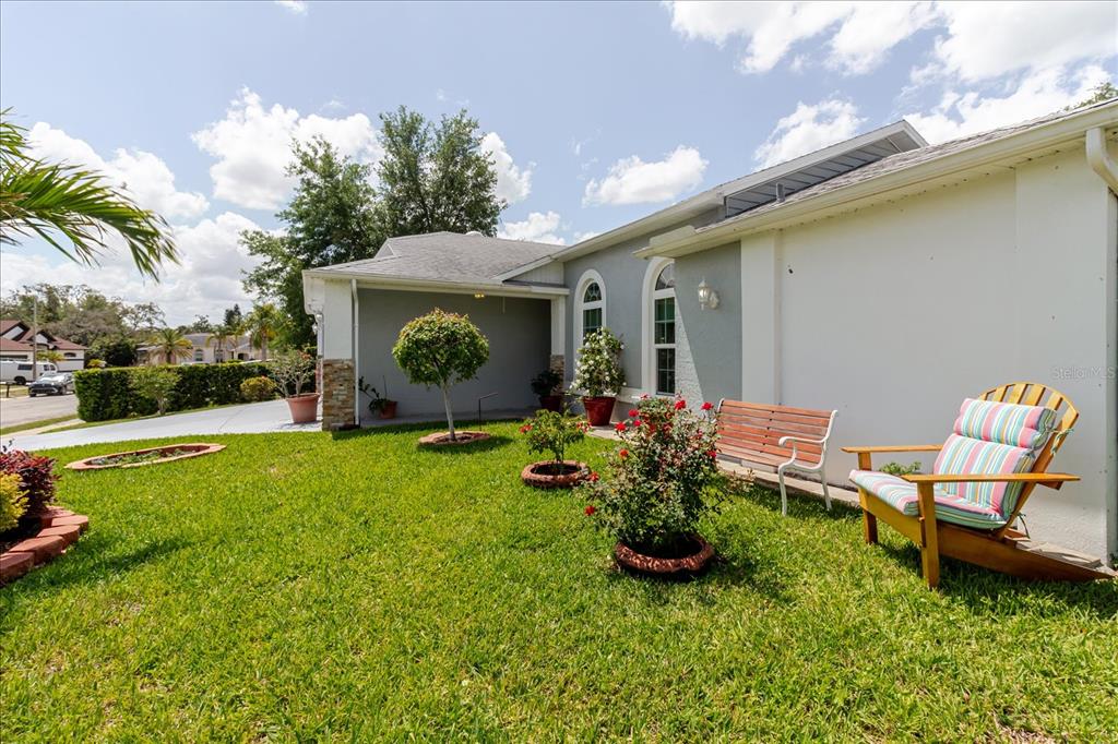 8112 Golden Bear Loop Port Richey, FL 34668 - Photo 12 of 88 a front view of a house with garden