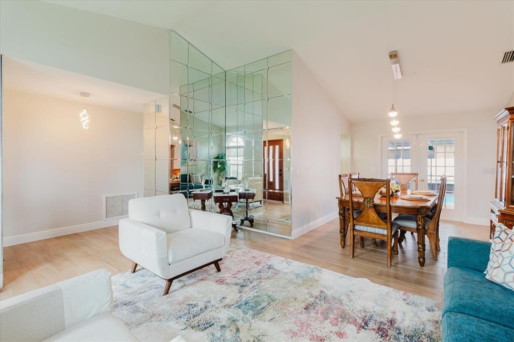 8112 Golden Bear Loop Port Richey, FL 34668 - Photo 18 of 88 a living room with furniture a dining table and a potted plant