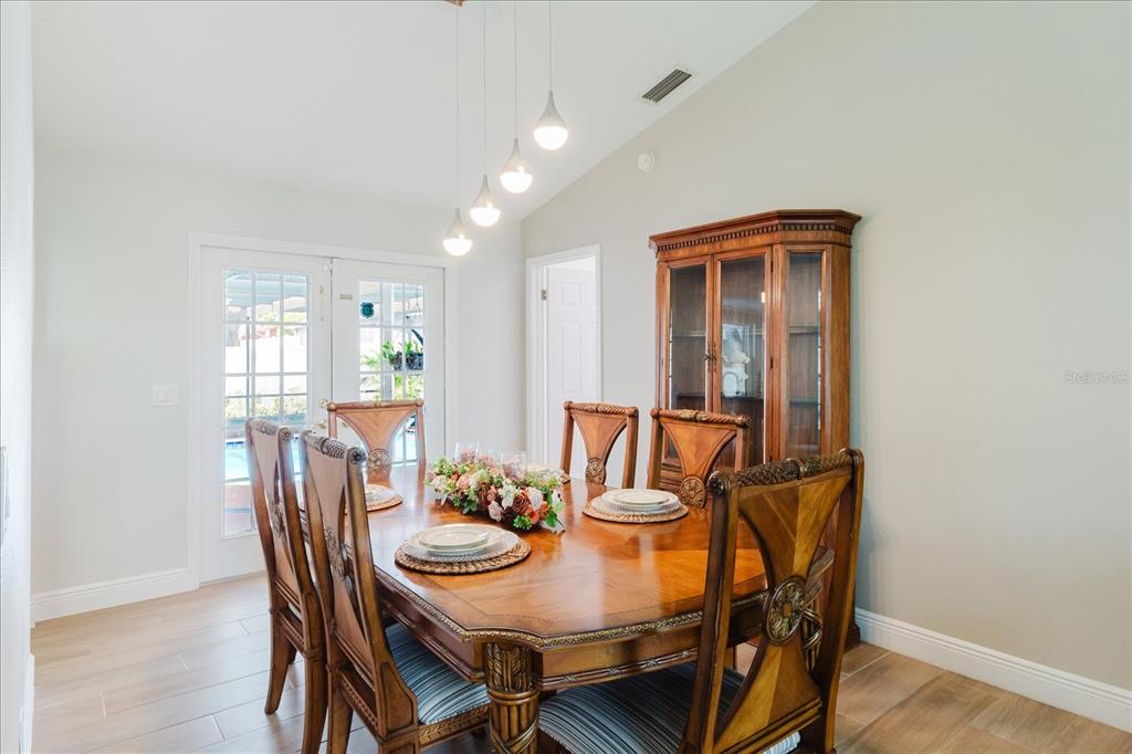 8112 Golden Bear Loop Port Richey, FL 34668 - Photo 22 of 88 a view of a dining room with furniture and wooden floor