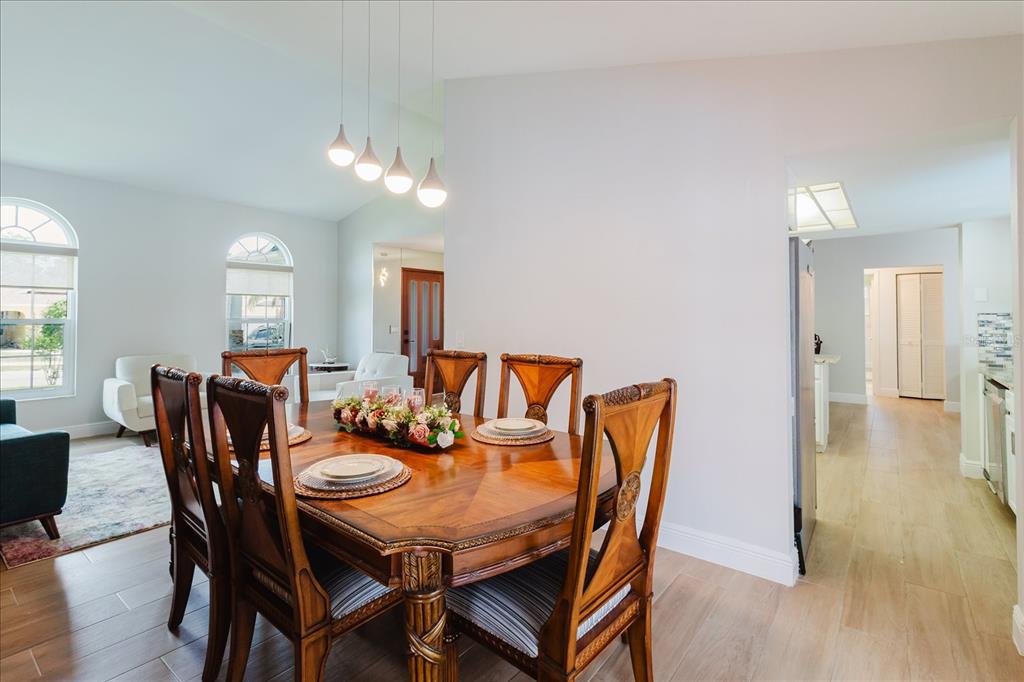 8112 Golden Bear Loop Port Richey, FL 34668 - Photo 24 of 88 a view of a dining room with furniture and wooden floor