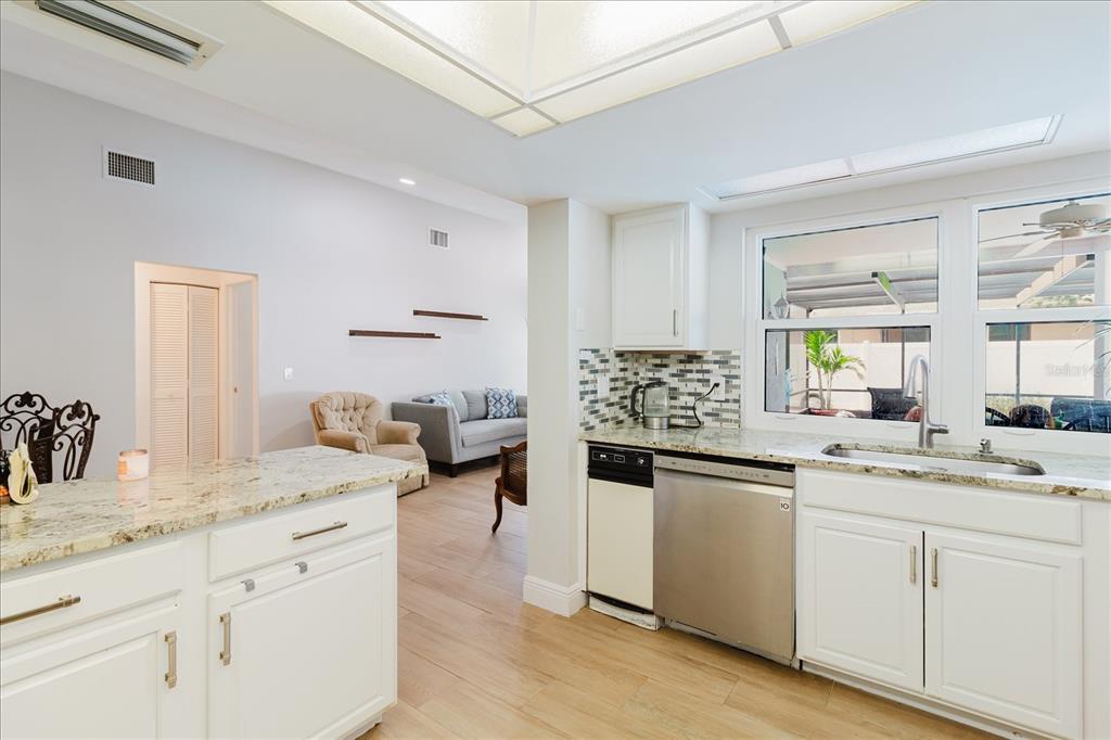 8112 Golden Bear Loop Port Richey, FL 34668 - Photo 29 of 88 a kitchen with stainless steel appliances kitchen island granite countertop a sink and cabinets