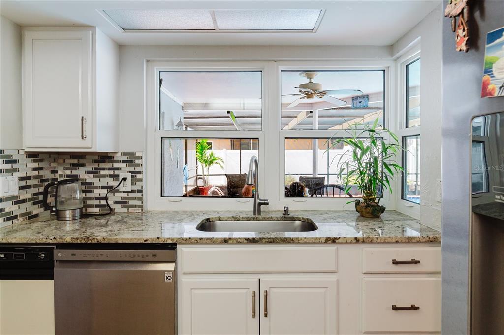 8112 Golden Bear Loop Port Richey, FL 34668 - Photo 30 of 88 a kitchen with sink a window and cabinets