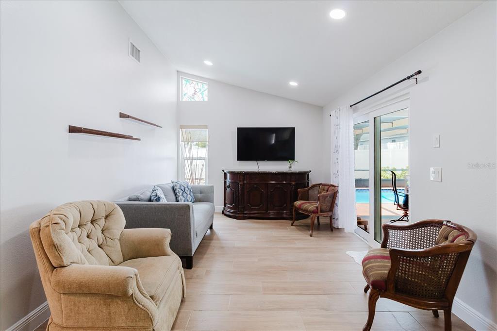 8112 Golden Bear Loop Port Richey, FL 34668 - Photo 36 of 88 a living room with furniture and a flat screen tv
